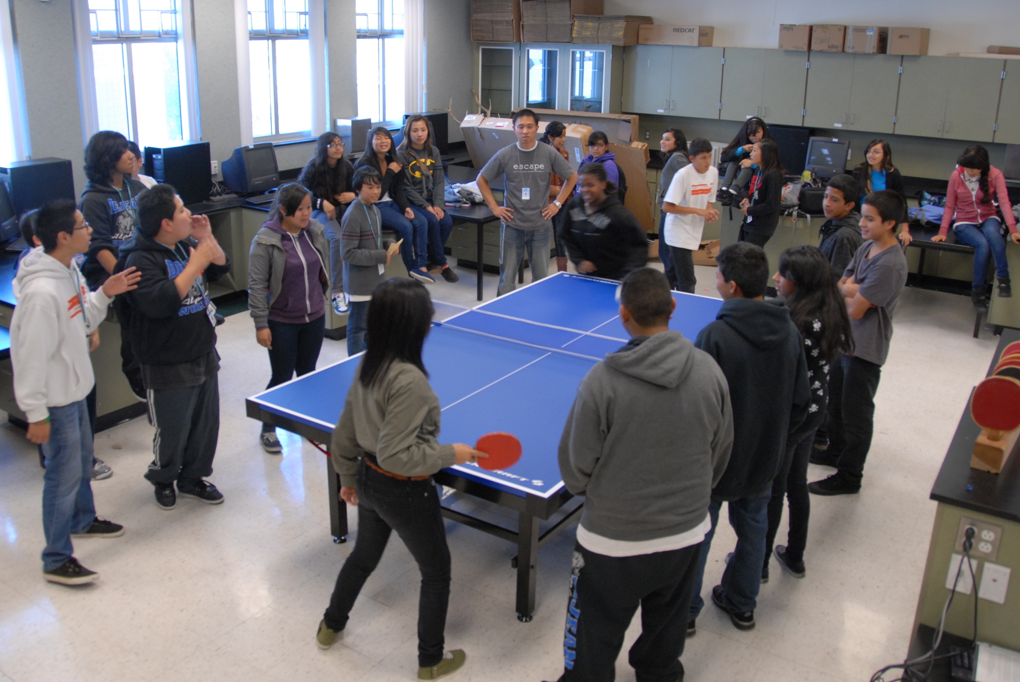 ESCAPE Club students playing ping pong after the meeting.